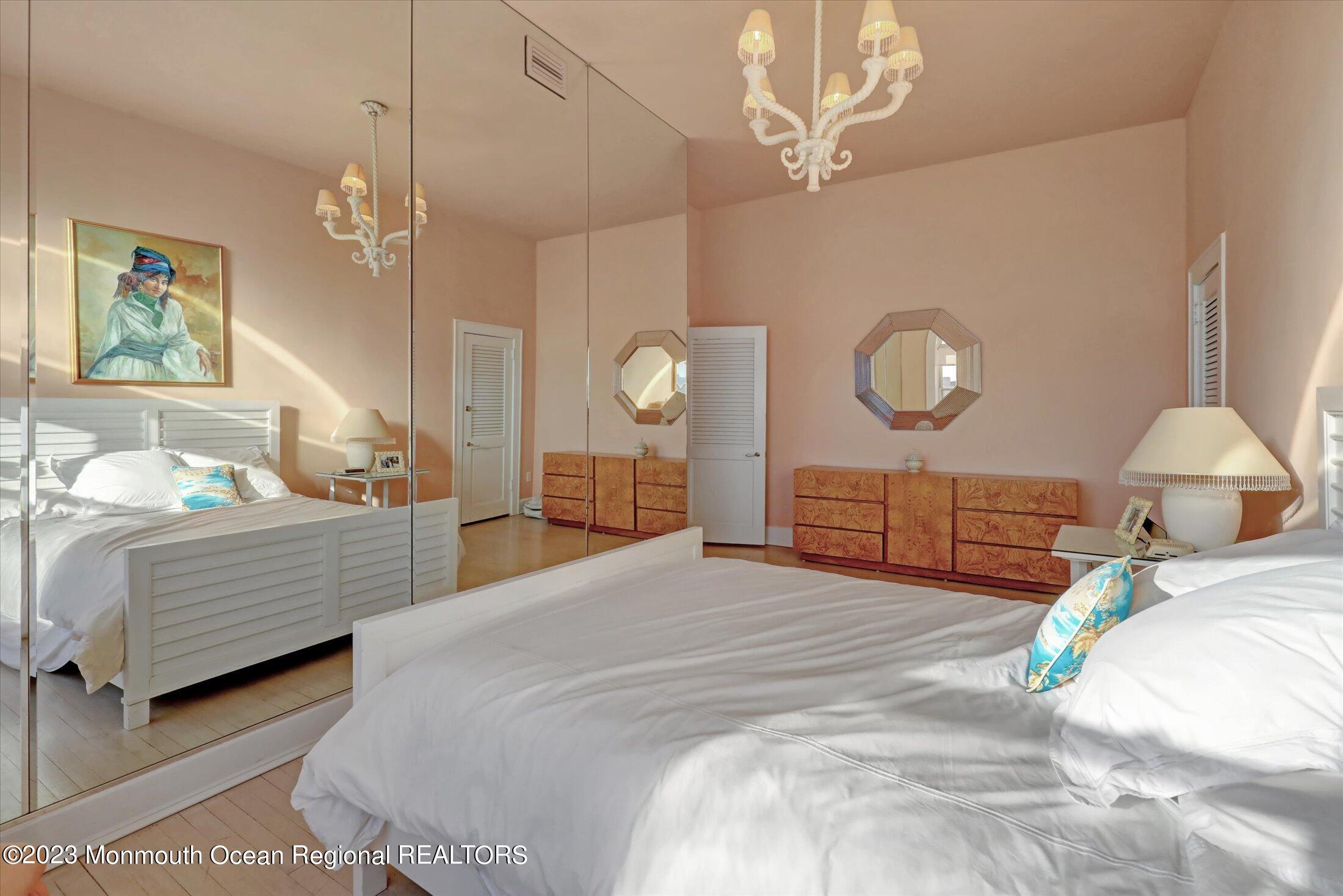 1 Roseld Avenue, Unit A3 Deal, NJ 07723 - Photo 20 of 35 a bedroom with a bed and a chandelier