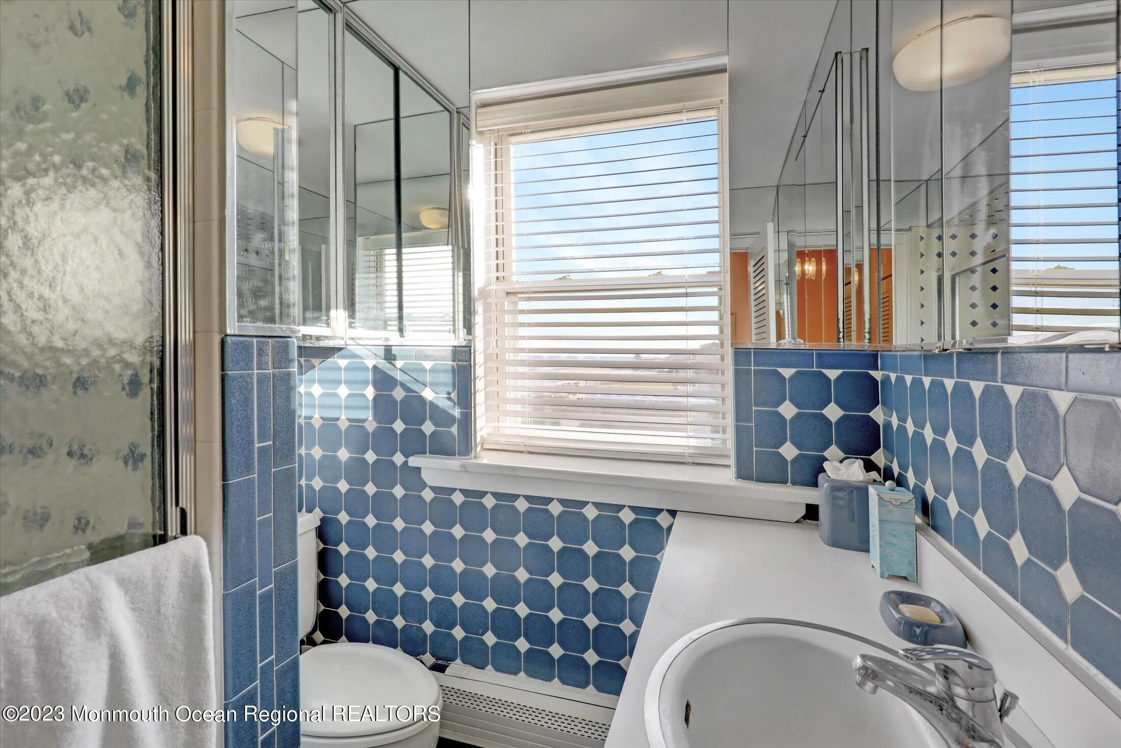1 Roseld Avenue, Unit A3 Deal, NJ 07723 - Photo 23 of 35 a bathroom with a sink a toilet and shower
