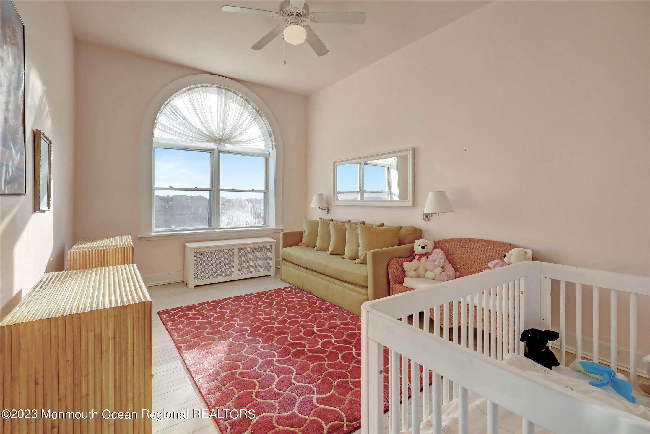 1 Roseld Avenue, Unit A3 Deal, NJ 07723 - Photo 24 of 35 a bedroom with furniture and a large window