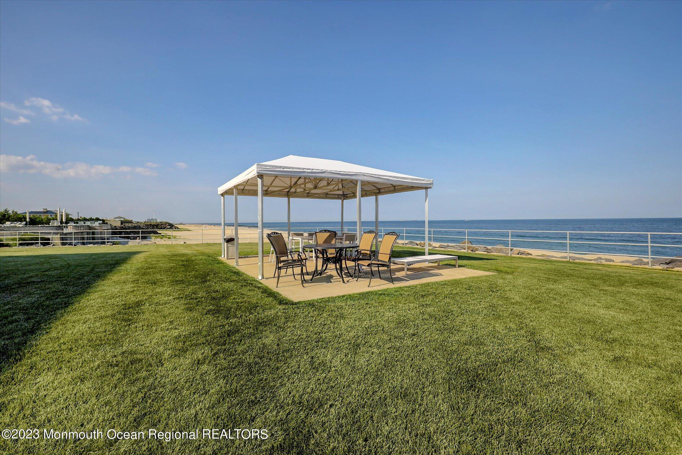 1 Roseld Avenue, Unit A3 Deal, NJ 07723 - Photo 30 of 35 a view of a swimming pool with outdoor seating and yard