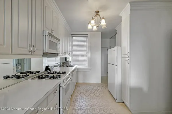 a kitchen with stainless steel appliances a refrigerator a sink dishwasher and cabinets