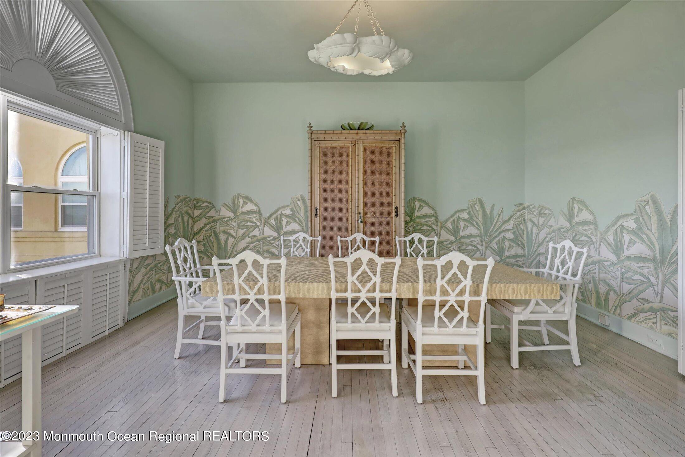 1 Roseld Avenue, Unit A3 Deal, NJ 07723 - Photo 8 of 35 a dining room with furniture a chandelier and wooden floor