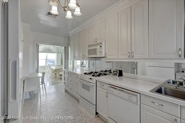 a kitchen with cabinets a sink and appliances