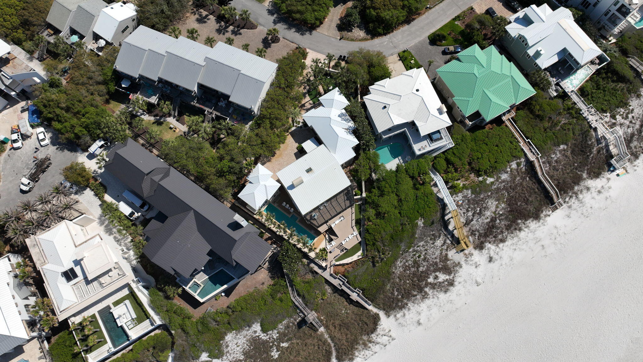 an aerial view of multiple houses with yard