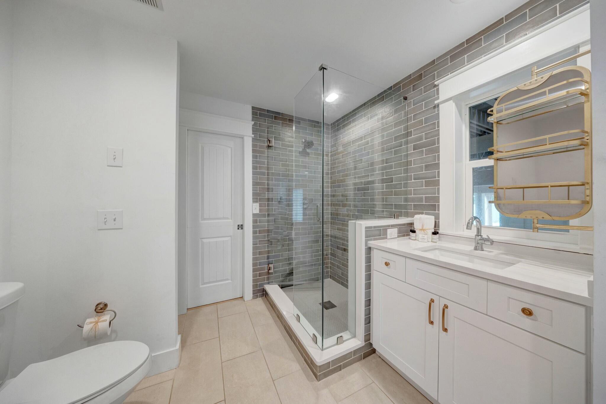 239 Pelican Circle Inlet Beach, FL 32461 - Photo 25 of 80 a bathroom with a double vanity sink toilet mirror and bathtub