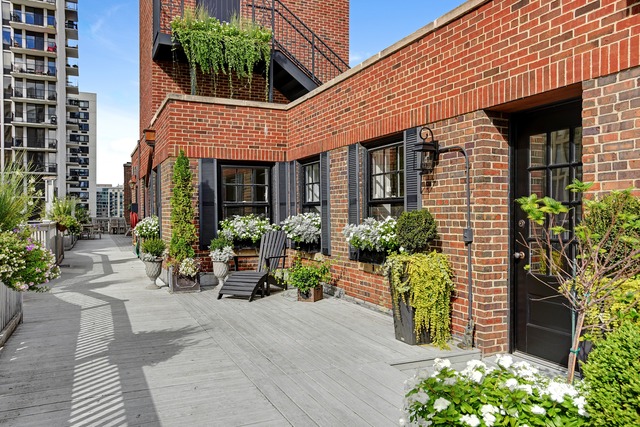 6 East Scott Street, Unit 6 Chicago, IL 60610 - Photo 24 of 25 front view of a brick house with potted plants