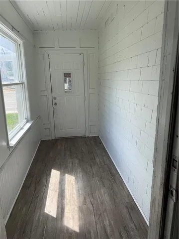 a view of a room with wooden floor and a window