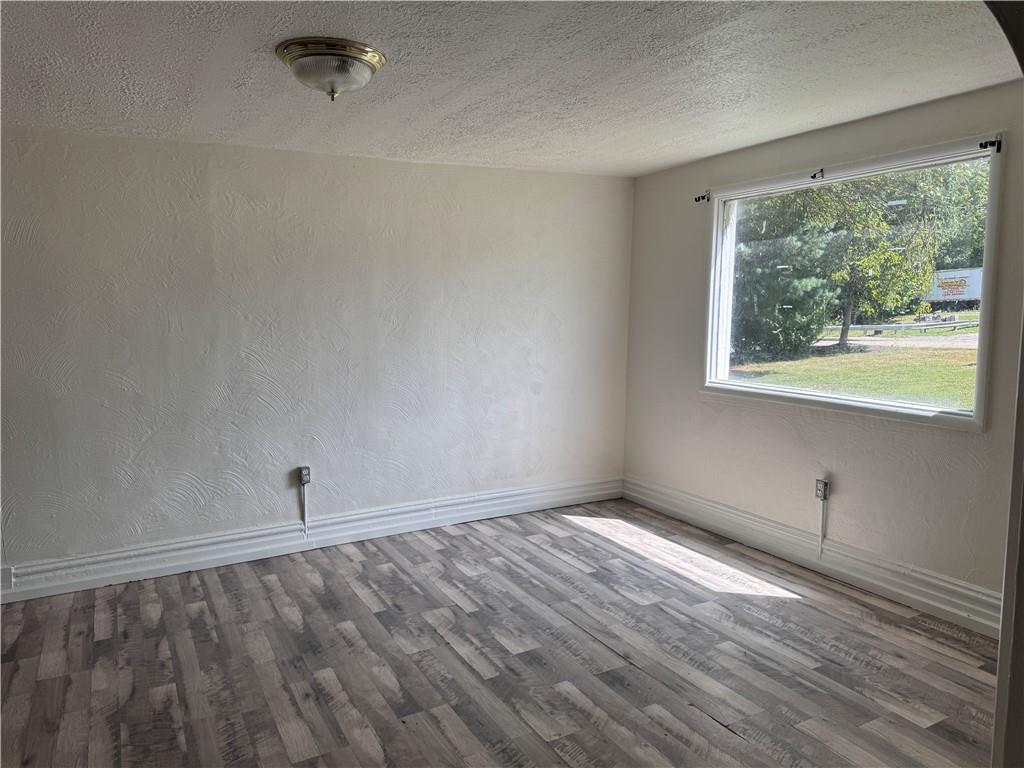 137 Sherman Avenue Vandergrift, PA 15690 - Photo 14 of 31 a view of an empty room with a window and wooden floor