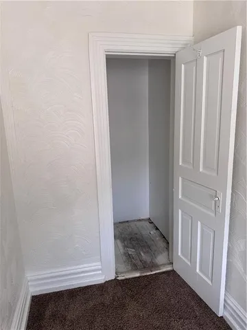a view of a room with closet and chandelier fan