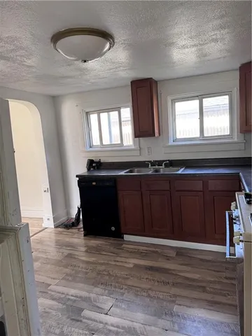 a kitchen with a sink and wooden cabinets