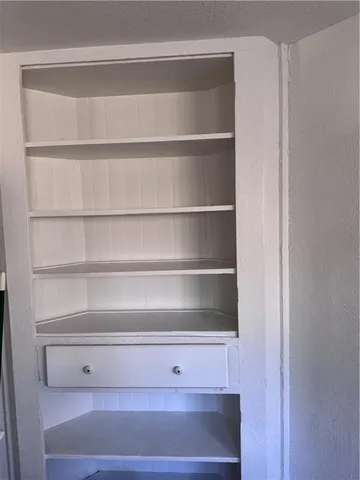 a kitchen with a refrigerator and a stove