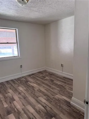 a view of a room with wooden floor