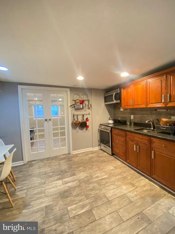 a kitchen with stainless steel appliances granite countertop a stove a sink and a refrigerator with cabinets