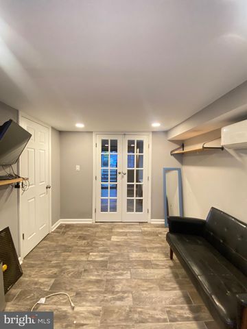 a view of empty room with wooden floor and windows