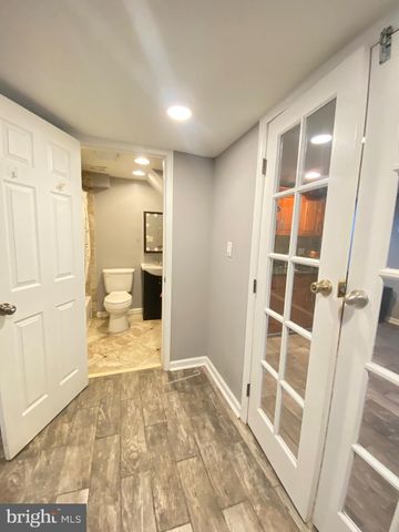 a view of a big room with wooden floor and windows