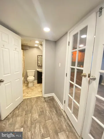 a view of a big room with wooden floor and windows