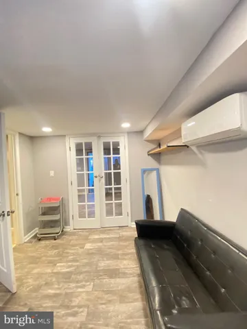 a view of empty room with wooden floor and windows