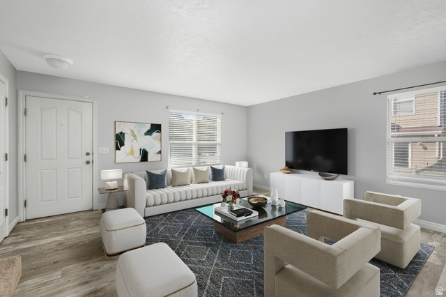7936 Wycliffe Way Eagle Mountain, UT 84005 - Photo 4 of 37 Living room featuring wood finished floors and healthy amount of natural light