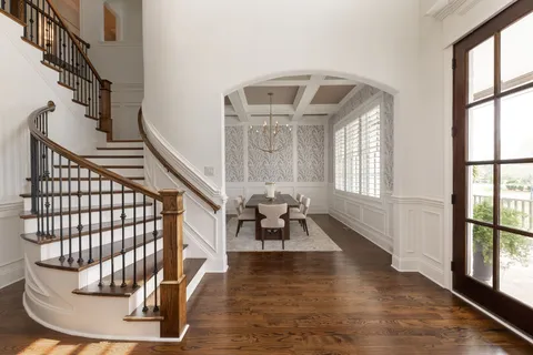 a living room with furniture a table and a chandelier