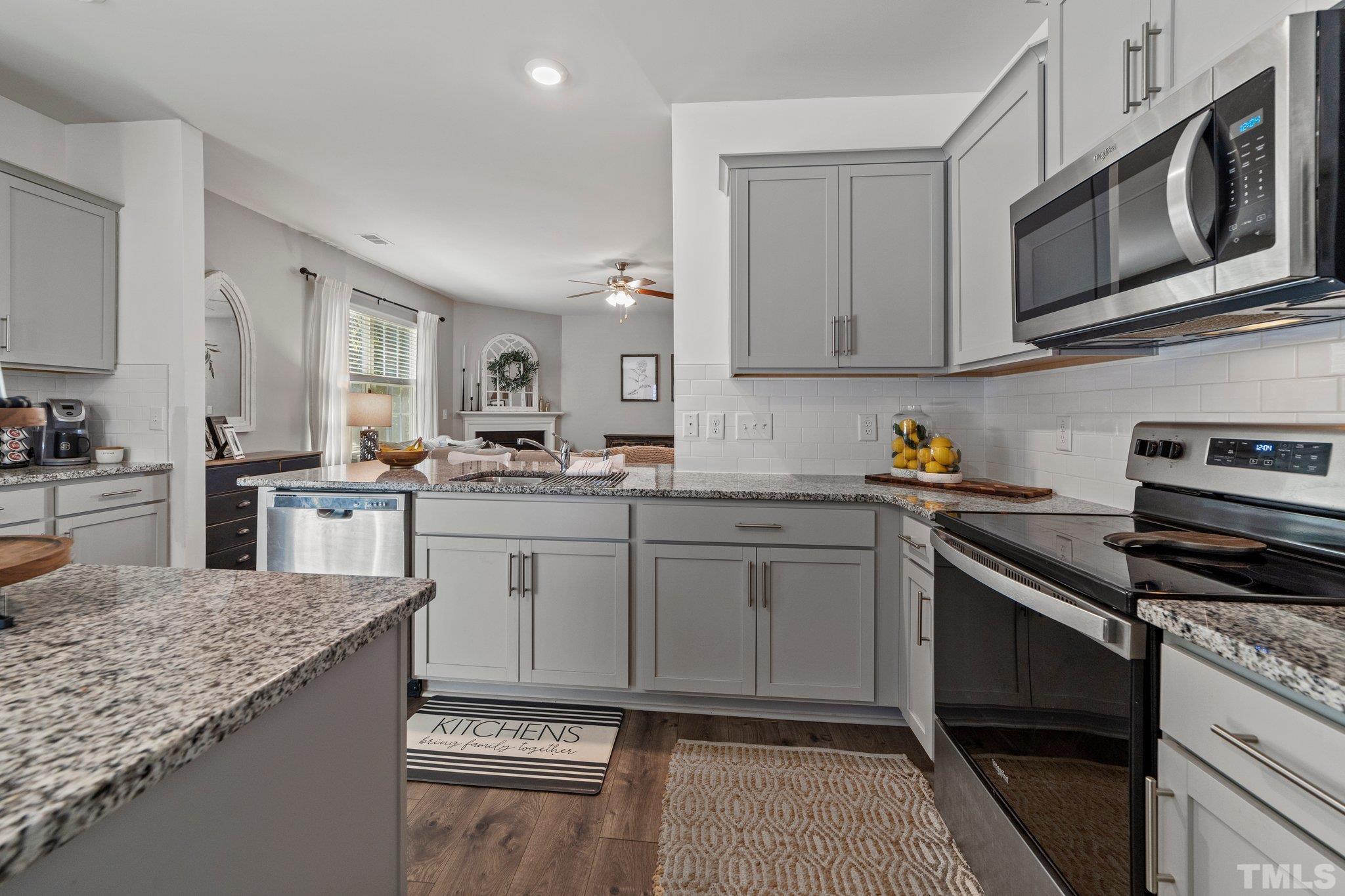 3116 Longpine Road Burlington, NC 27215 - Photo 11 of 29 a kitchen with stainless steel appliances granite countertop a sink stove microwave and cabinets
