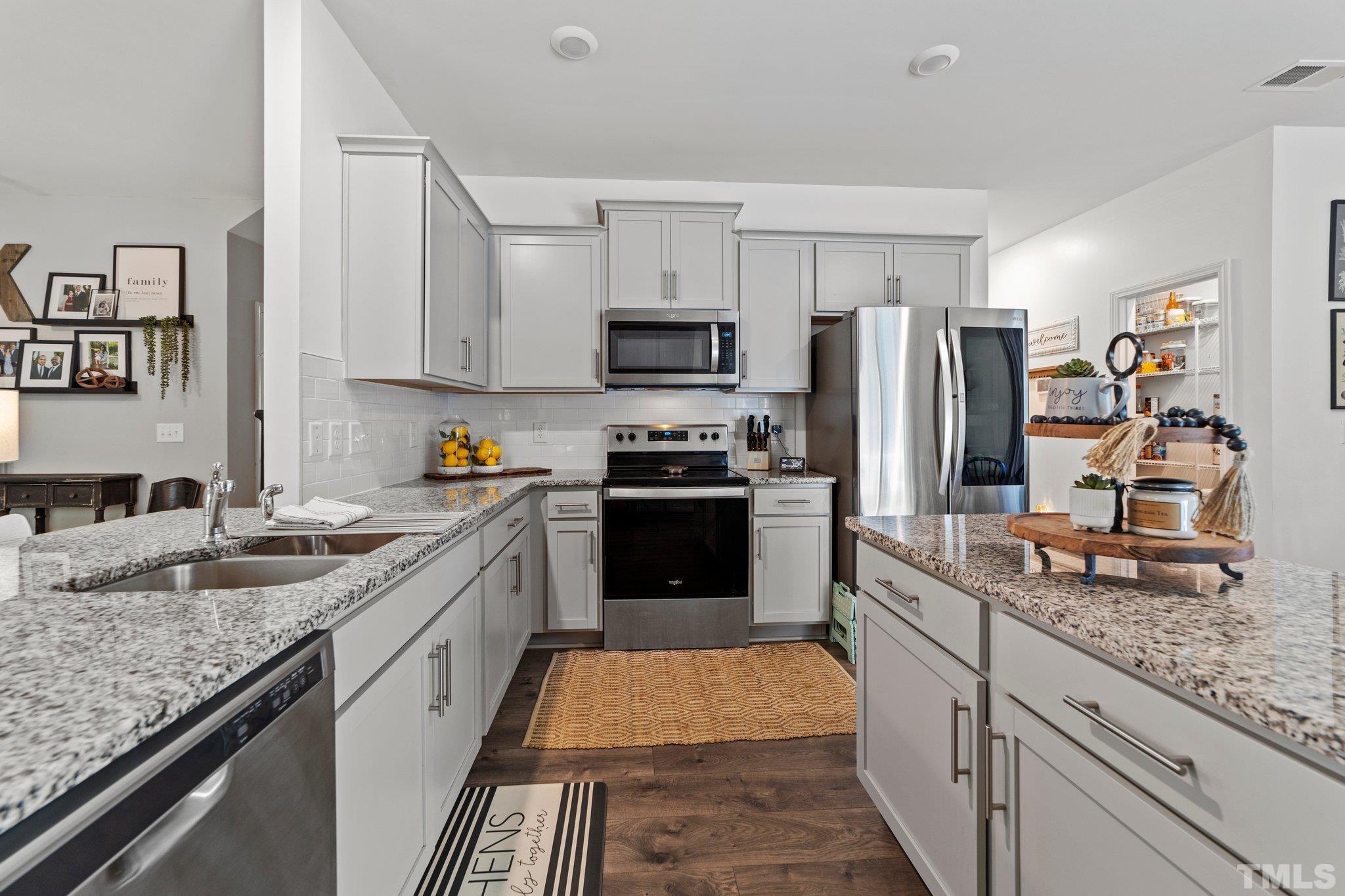 3116 Longpine Road Burlington, NC 27215 - Photo 12 of 29 a kitchen with granite countertop stainless steel appliances and counter space