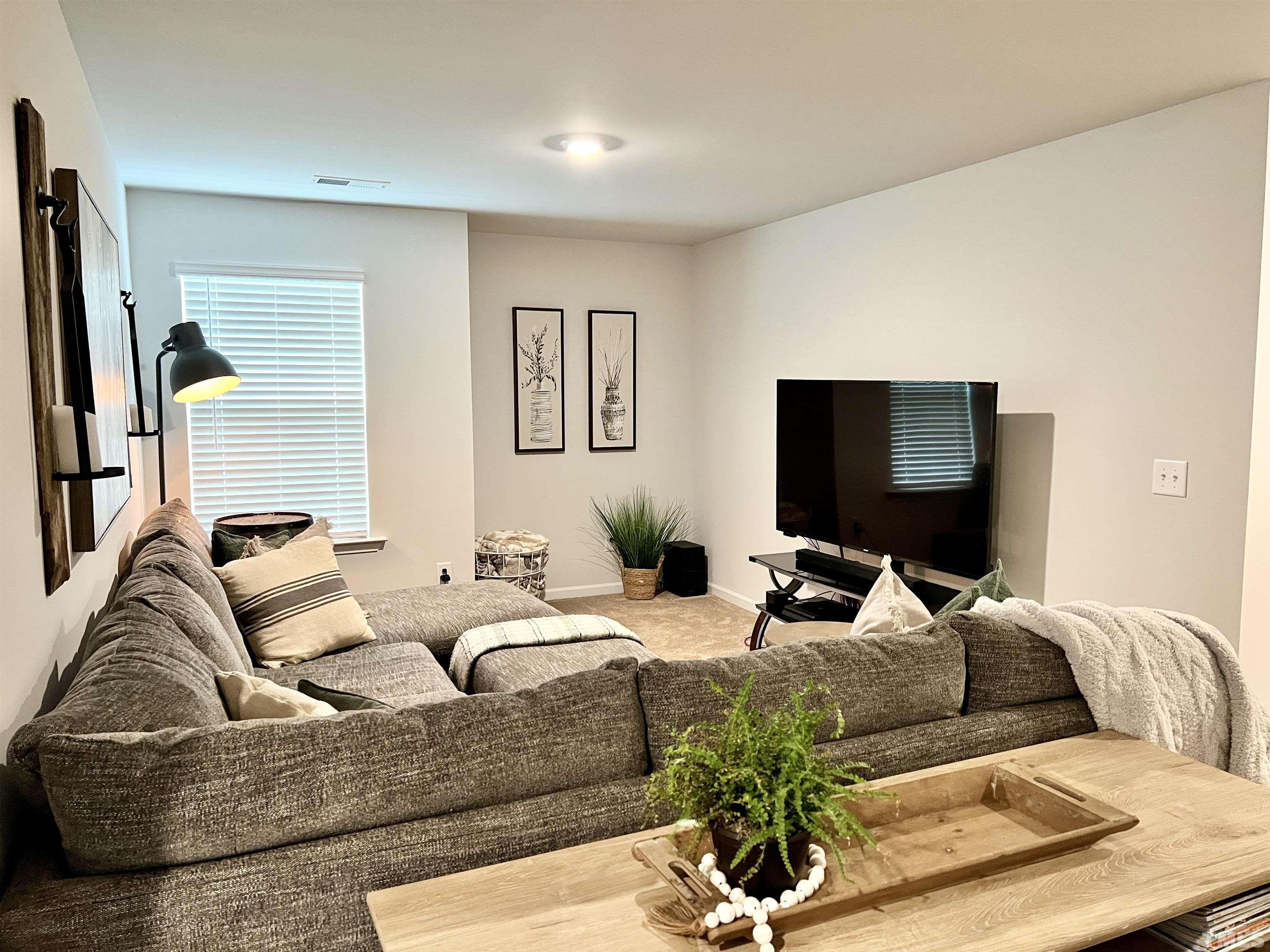 3116 Longpine Road Burlington, NC 27215 - Photo 20 of 29 a living room with furniture and a flat screen tv