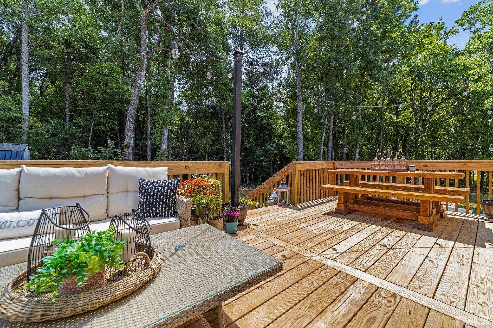 3116 Longpine Road Burlington, NC 27215 - Photo 3 of 29 a view of a patio with couches table and chairs with wooden floor and fence