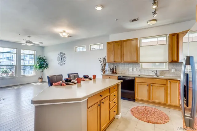 a kitchen with a sink a stove and cabinets