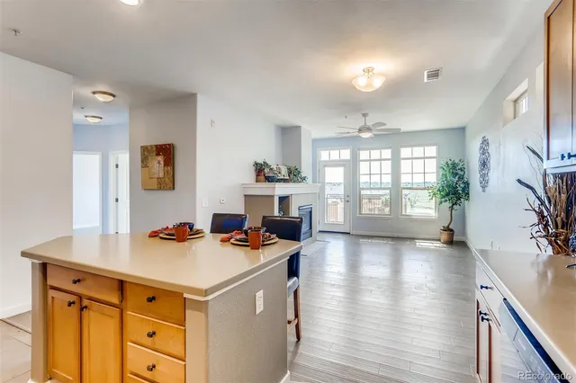 a view of an empty room with a window and fireplace