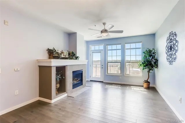 a kitchen with stainless steel appliances kitchen island granite countertop a table chairs and a refrigerator