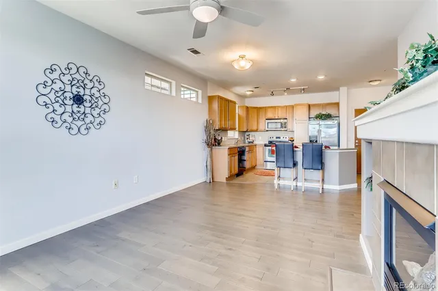 a kitchen with a table chairs refrigerator and cabinets
