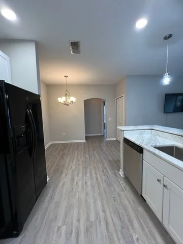 a view of a kitchen counter space and wooden floor