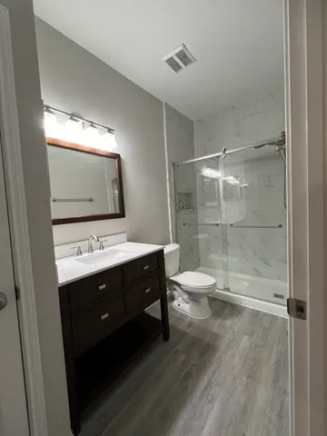 a bathroom with a sink shower and a mirror