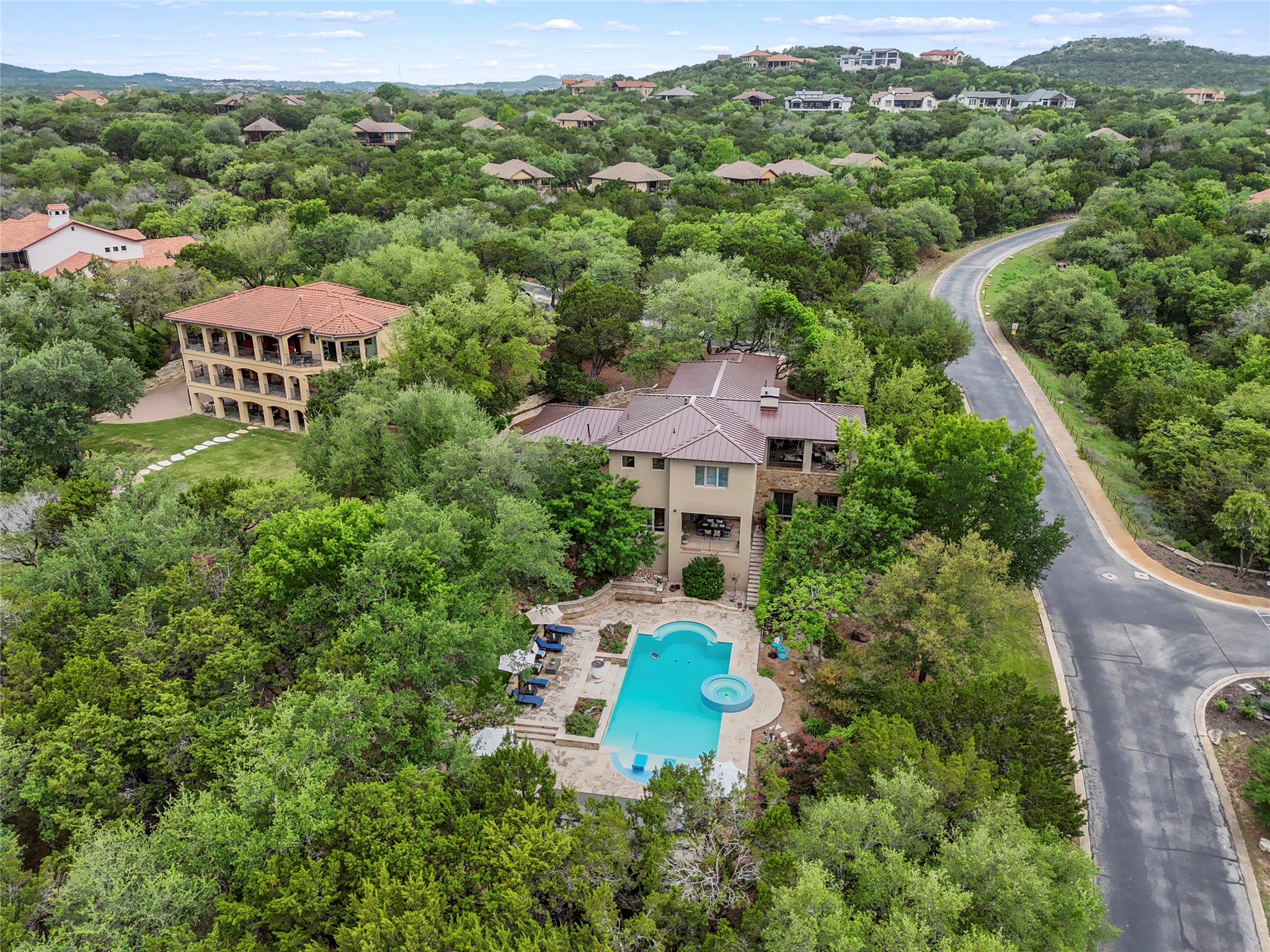 17501 Navigation Lane Lago Vista, TX 78645 - Photo 40 of 40 Aerial view of the property featuring a pool, a spa, and a surrounding patio