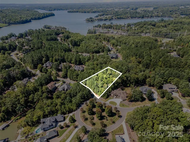 an aerial view of a residential apartment building with a yard