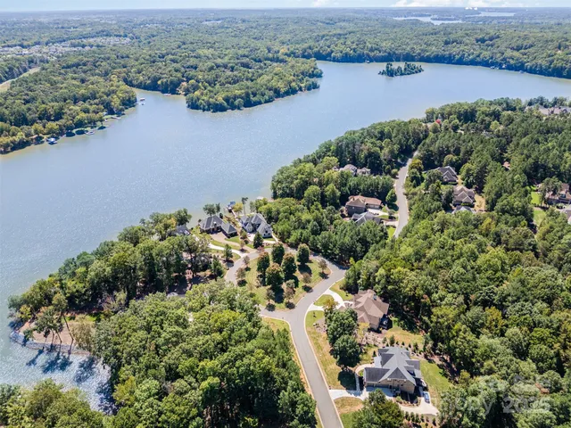 an aerial view of a houses with a lake view