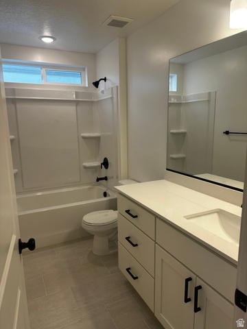 61 South Lunar Way Mapleton, UT 84664 - Photo 14 of 15 Bathroom with vanity, tub / shower combination, and a textured ceiling