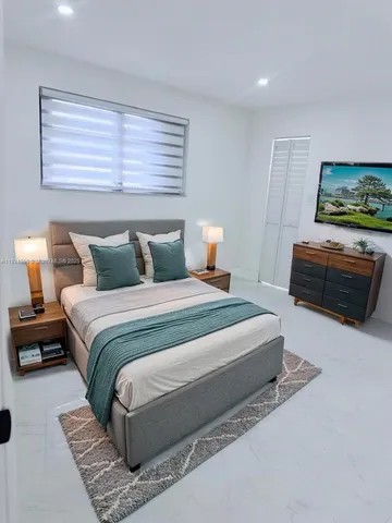 a bathroom with a bathtub sink mirror and toilet