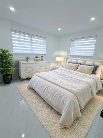 a bathroom with a double vanity sink toilet and mirror