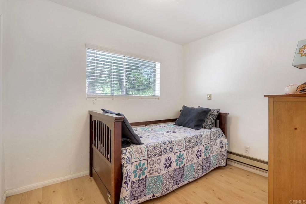 22223 Crestline Road Palomar Mountain, CA 92060 - Photo 43 of 90 a bedroom with a bed and wooden floor