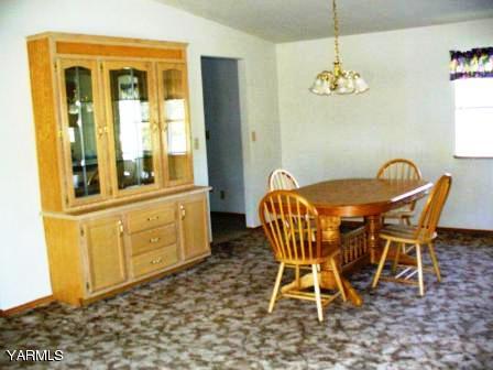208 North Rivard Road Moxee, WA 98936 - Photo 2 of 2 a view of a dining room with furniture and chandelier