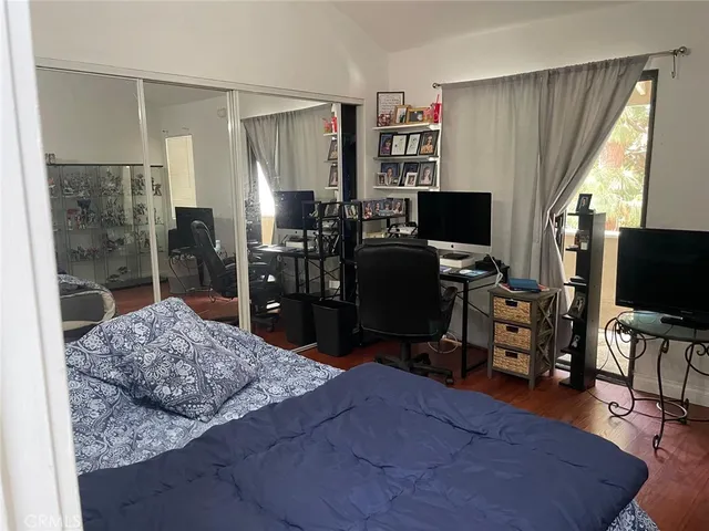 a bedroom with furniture and a flat screen tv