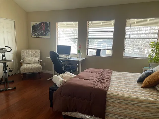 a bed sitting in a bedroom next to a window