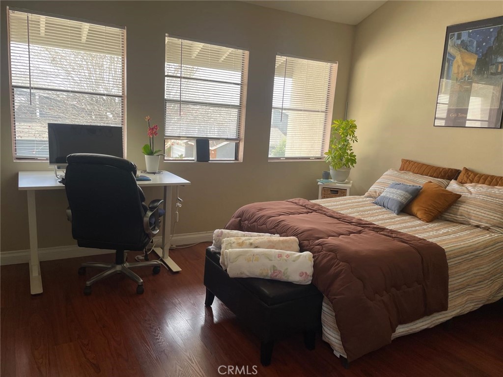 404 Brighton Springs Costa Mesa, CA 92627 - Photo 16 of 22 a bedroom with a bed chair and windows