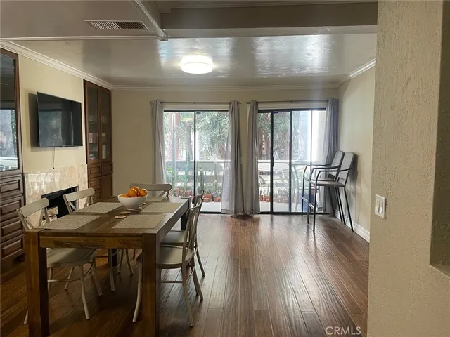 a view of a livingroom with furniture window and wooden floor