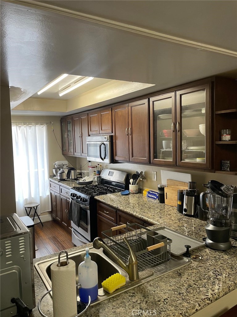 404 Brighton Springs Costa Mesa, CA 92627 - Photo 6 of 22 a kitchen with a stove a sink and a counter top space