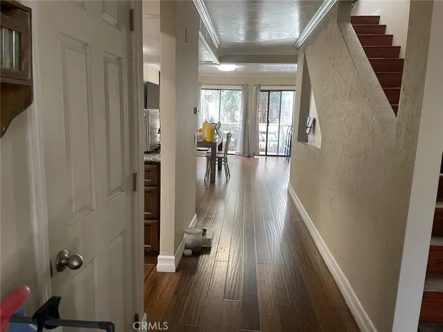 a view of hallway with wooden floor