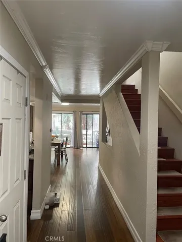 a view of dining room with wooden floor and stairs
