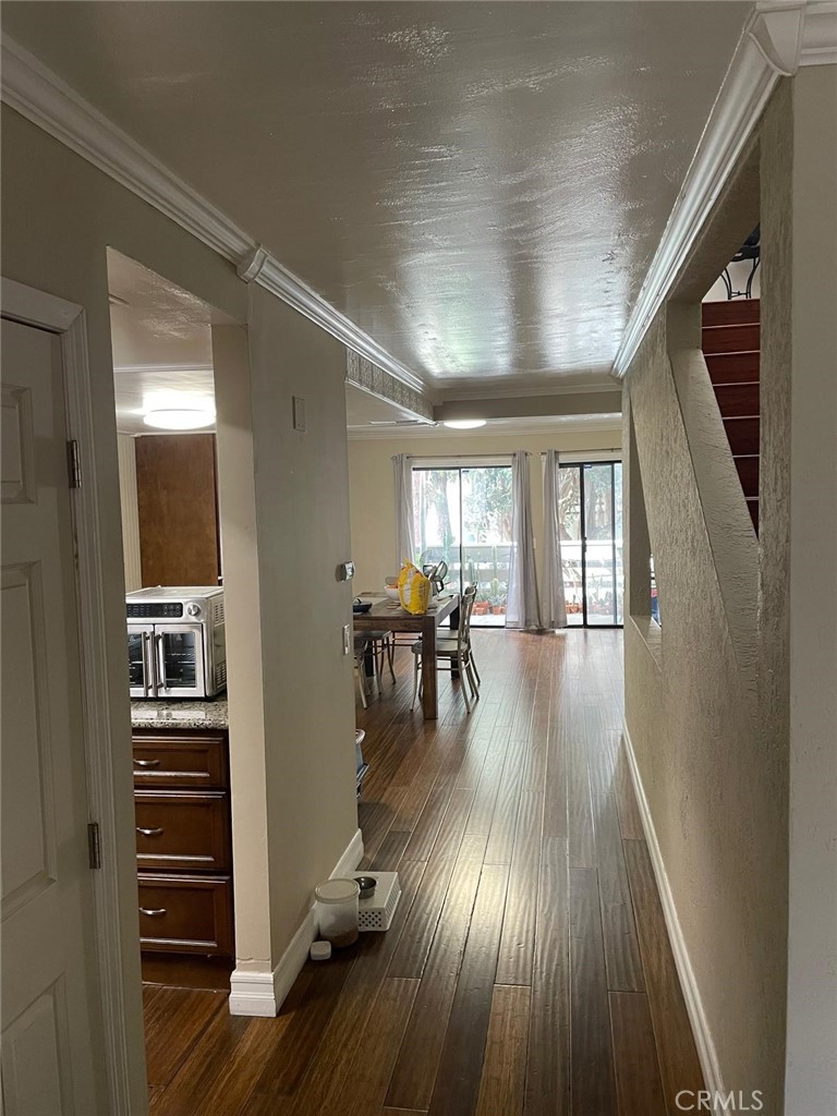 404 Brighton Springs Costa Mesa, CA 92627 - Photo 10 of 22 a view of a hallway with wooden floor and windows