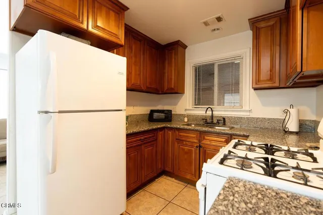 a kitchen with a sink a stove and a refrigerator